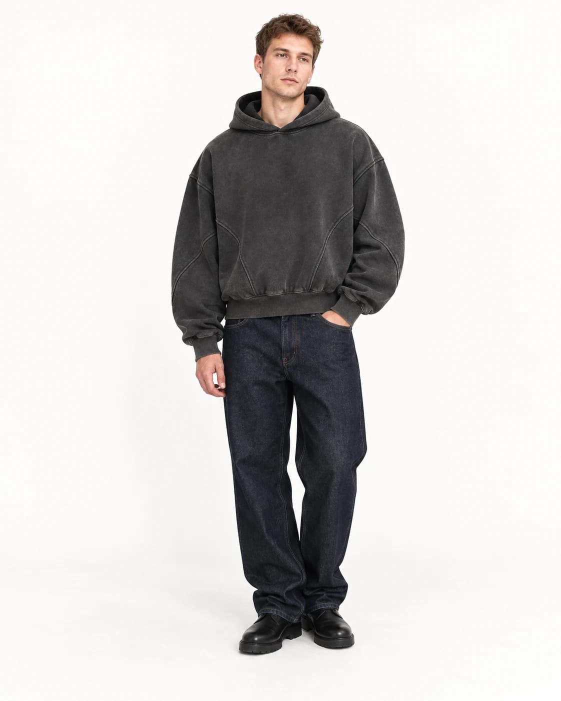 Model standing casually while showing the clean front of the FrameClo hoodie